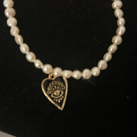 Beautiful pearl bracelet with evil eye heart drop